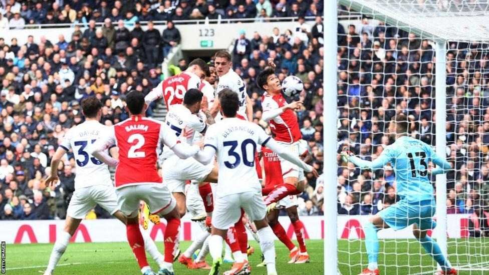 Arsenal survive Spurs rally to go four points clear