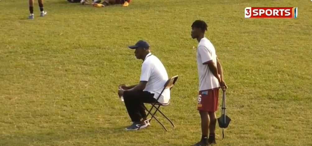 Heart of Lions coach Bashir Hayford sits in middle of pitch during match